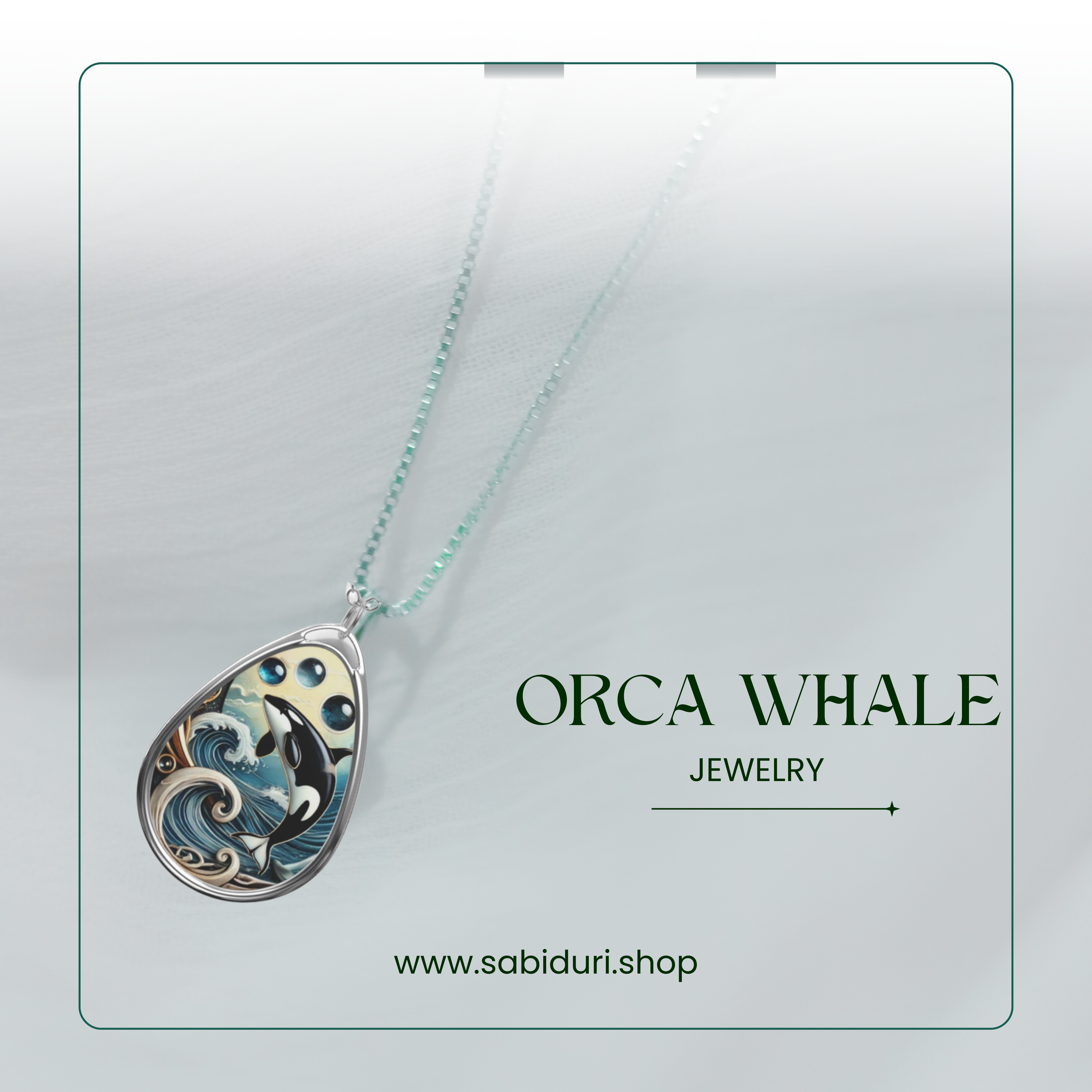 A teardrop-shaped pendant showcasing an orca whale jumping out of stylized waves, accented by three blue gemstones above the orca. The pendant is displayed on a light, textured background with the text "ORCA WHALE" and "JEWELRY" to the right, and the website "www.sabiduri.shop" at the bottom.