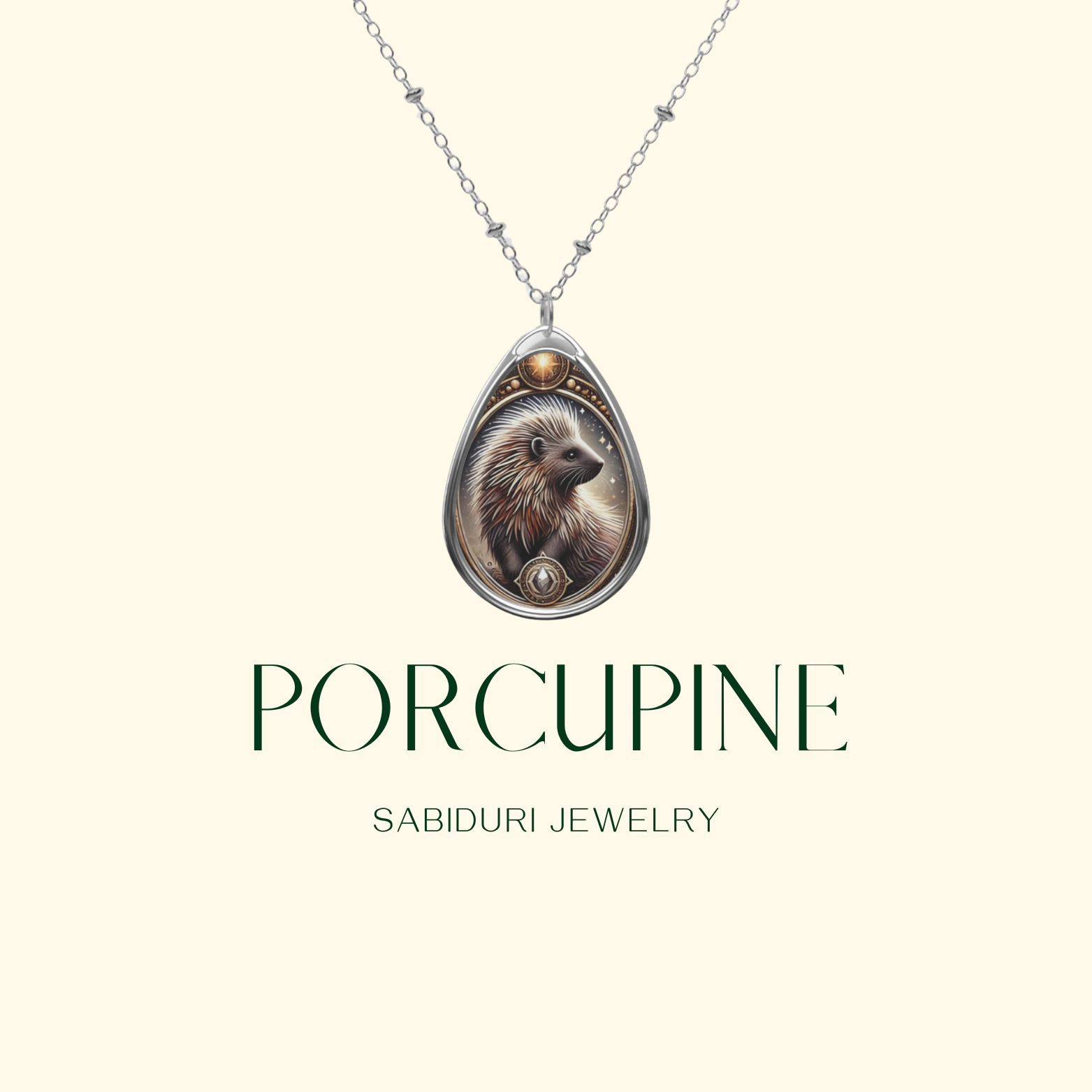 A teardrop-shaped pendant featuring an intricately detailed porcupine, surrounded by golden filigree and celestial accents. The design captures the porcupine’s quills in a soft glow, enhancing the artistic depth. Below, "PORCUPINE" is elegantly displayed, followed by "SABIDURI JEWELRY" on a minimalist background.