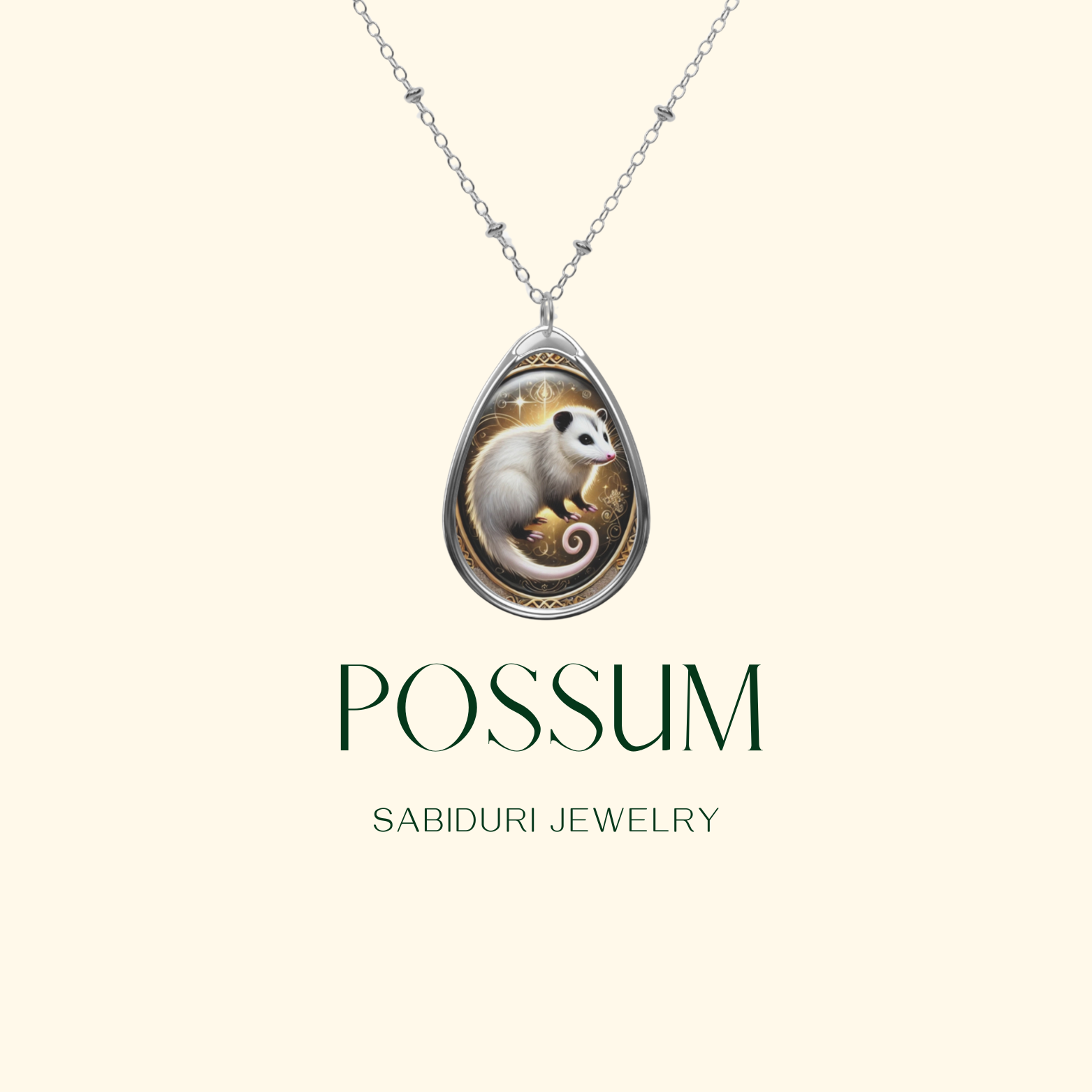  A teardrop-shaped silver pendant featuring an intricately designed possum illustration with soft white fur and a curled tail. The background inside the pendant has golden accents and delicate filigree details. Below the pendant, the text "POSSUM" and "SABIDURI JEWELRY" is elegantly displayed.