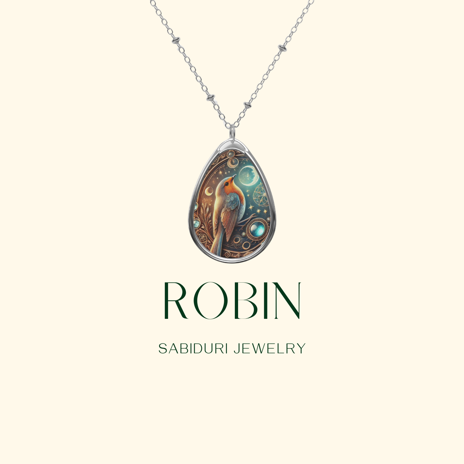 A robin necklace pendant displayed against a light beige background. The pendant showcases a detailed robin illustration with celestial elements, accompanied by the text "ROBIN" and "SABIDURI JEWELRY" in elegant typography.