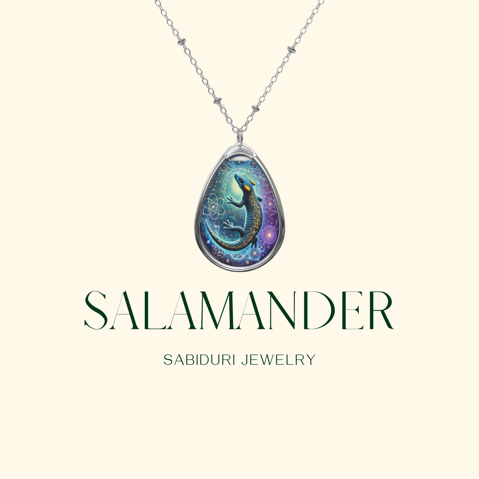 A close-up of a teardrop pendant necklace featuring a luminous blue and black salamander with cosmic and geometric details. The chain has delicate metalwork, and "SALAMANDER" and "SABIDURI JEWELRY" are written in elegant typography.