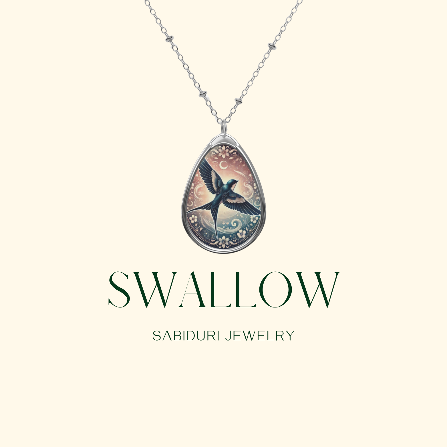 A close-up of the swallow pendant necklace on a minimalist cream-colored background. The pendant showcases a dark-feathered swallow with outstretched wings, surrounded by delicate floral patterns and a glowing sky. The words "SWALLOW" and "SABIDURI JEWELRY" are elegantly displayed.