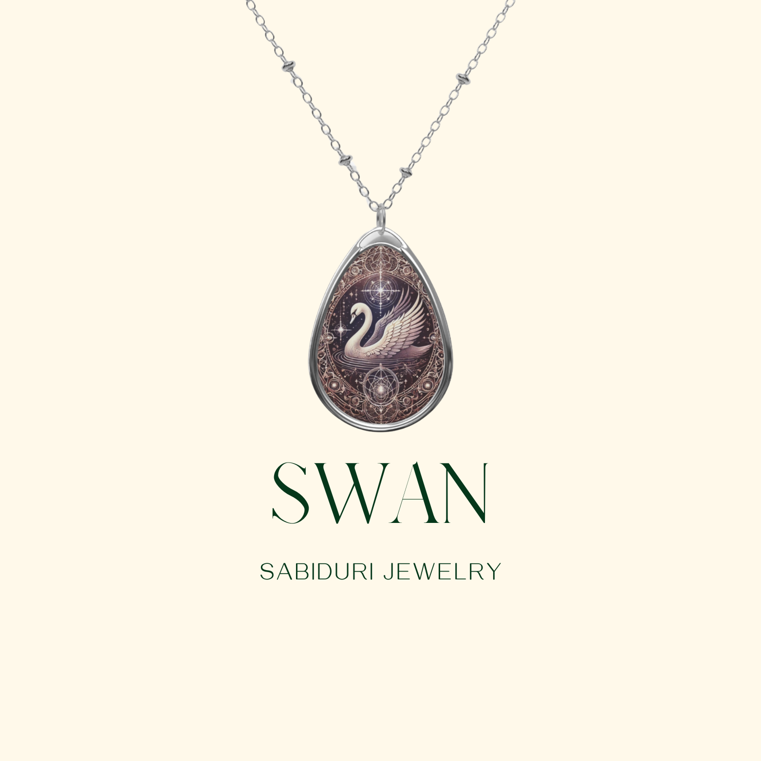 A silver chain necklace with a teardrop-shaped pendant showcasing a detailed swan illustration in a celestial setting. The image has a minimalist, cream-colored background with "SWAN" and "SABIDURI JEWELRY" in a refined, modern font.