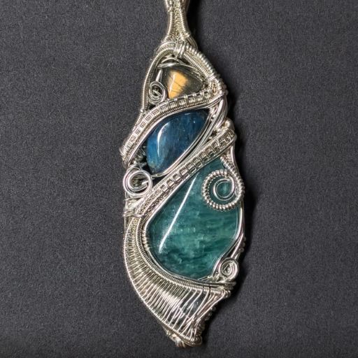 An elegant, wire-wrapped pendant featuring a large aqua-blue stone with a smaller amber-colored stone above, intricately entwined with silver wire on a dark background.