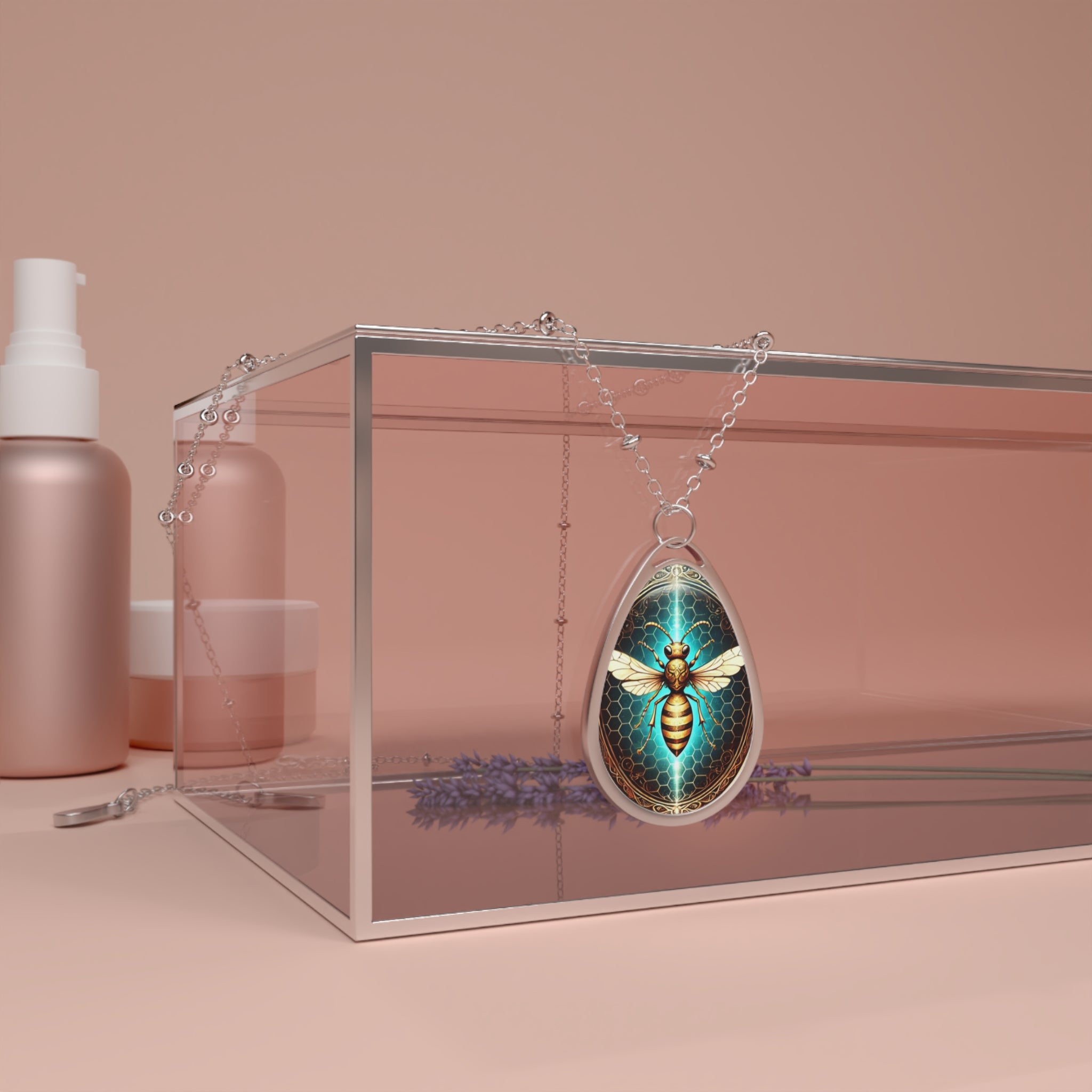 A striking wasp pendant necklace elegantly draped over a clear display case, surrounded by pastel beauty products and lavender sprigs. The pendant's vibrant blue and gold tones reflect beautifully, making it a standout jewelry piece.