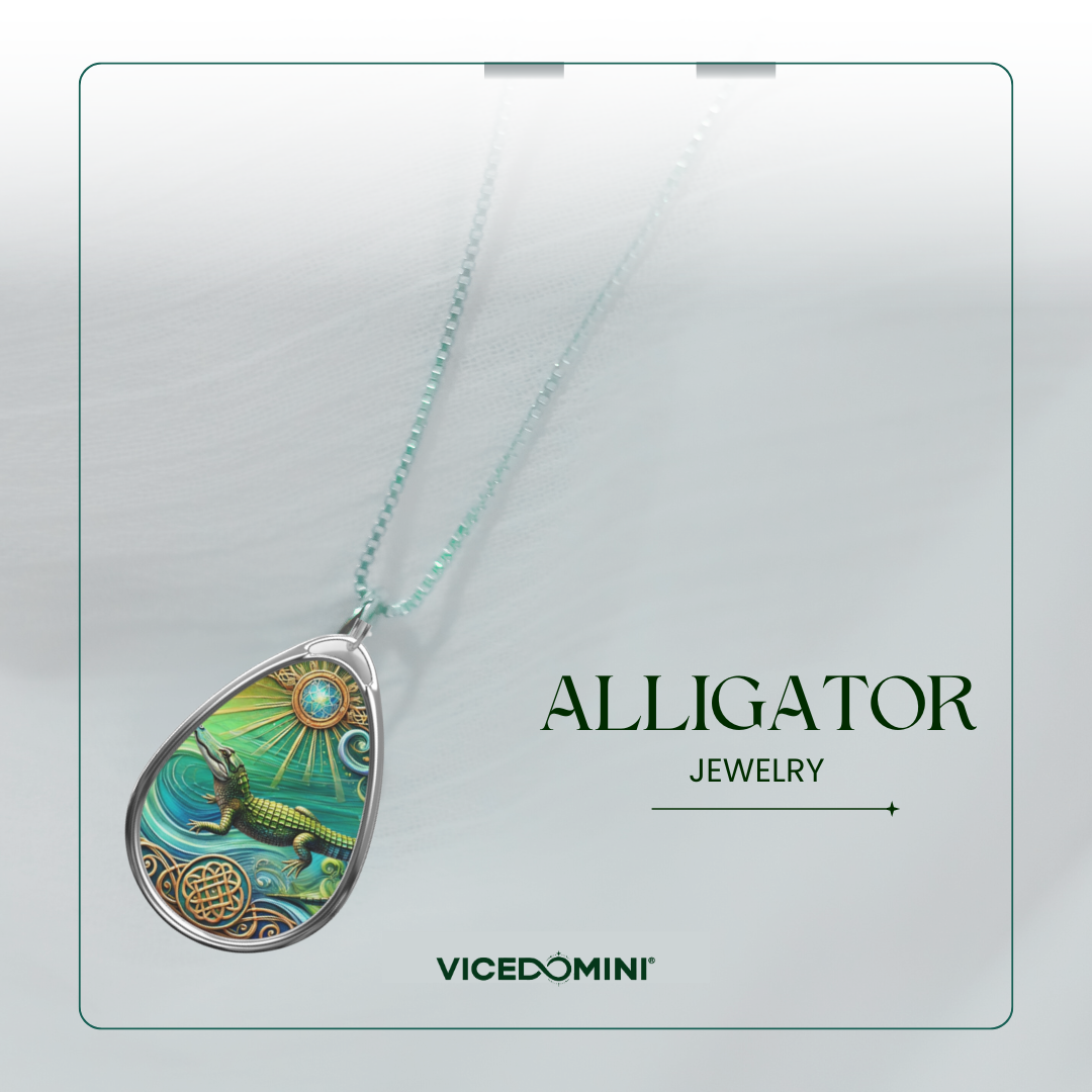 A teardrop pendant necklace featuring a colorful alligator illustration on a mint green and turquoise background, suspended from a matching mint green chain. The pendant is displayed on a light gray card with the text 'ALLIGATOR JEWELRY' and the brand 'VICEDOMINI'.