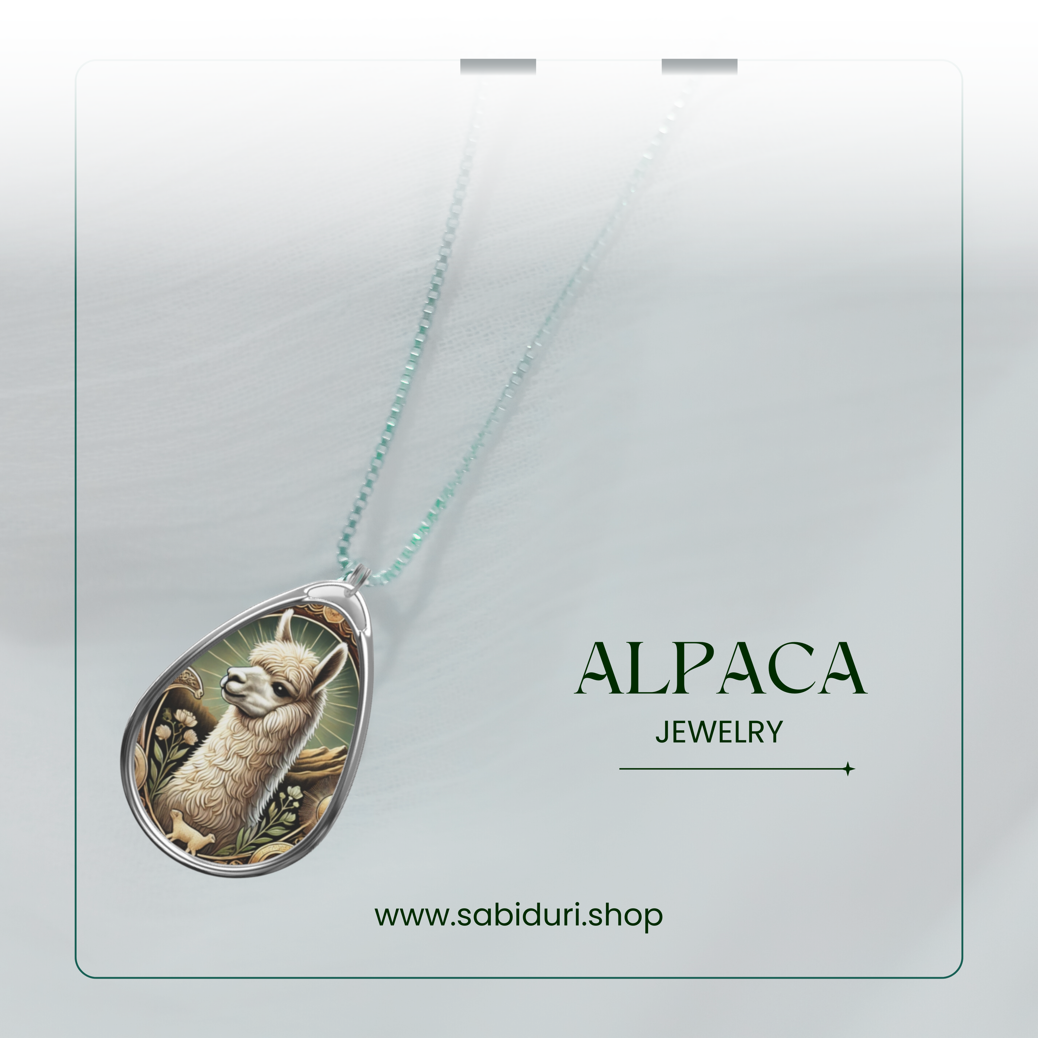 A close-up of a silver alpaca pendant necklace, featuring an elaborate nature-inspired design with warm golden tones and floral embellishments. The pendant rests on a soft white fabric background, with the words "ALPACA JEWELRY" and the website "www.sabiduri.shop" in an elegant green font.