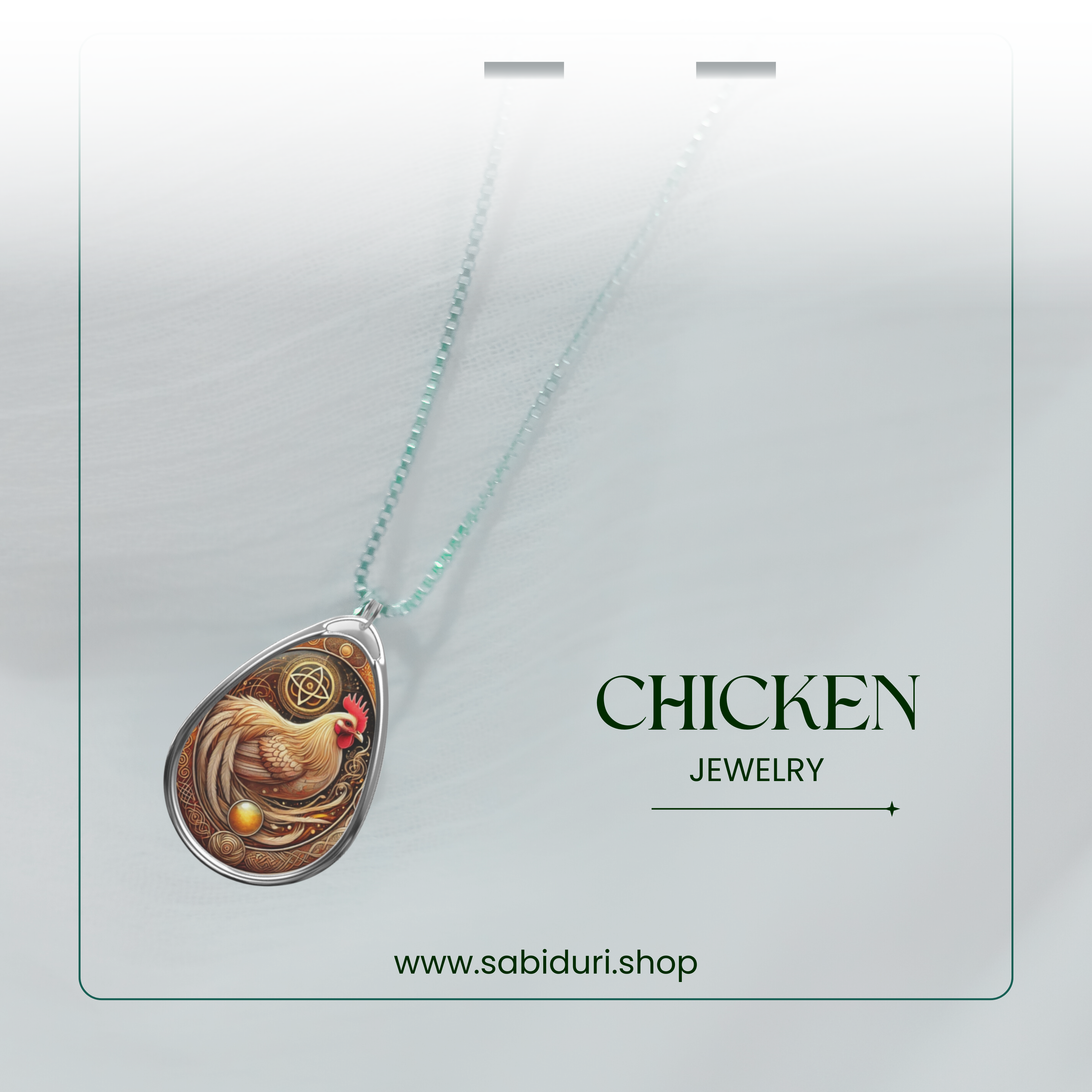 A stylish product showcase of the cormorant necklace against a semi-transparent white backdrop. The pendant, featuring a black cormorant with gold and blue accents, hangs from a delicate silver chain. The text "CORMORANT JEWELRY" and "www.sabiduri.shop" is positioned to highlight the brand.