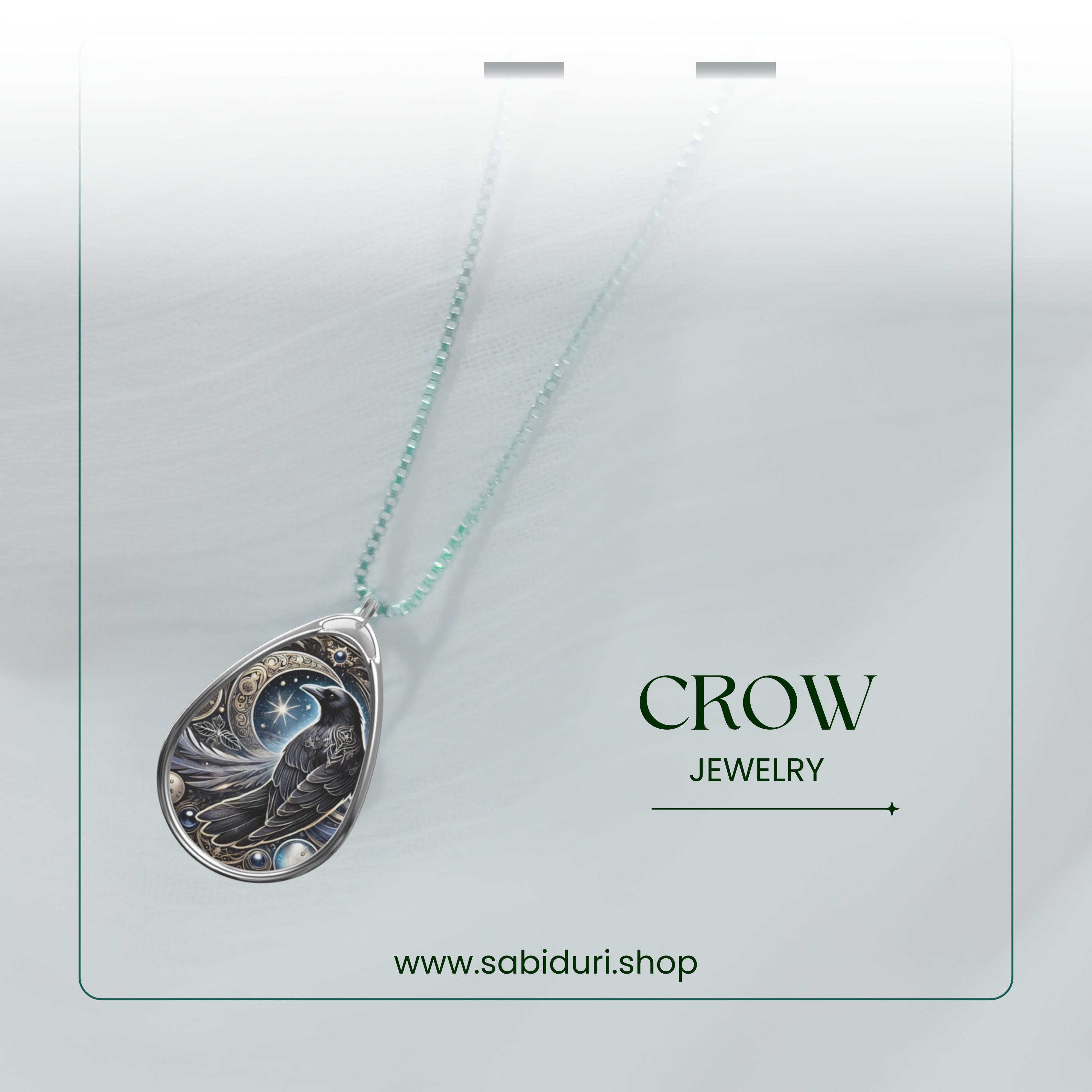 The crow pendant necklace is displayed against a soft, airy white background, hanging from a delicate beaded chain. The text "CROW JEWELRY" and "www.sabiduri.shop" complement the design.