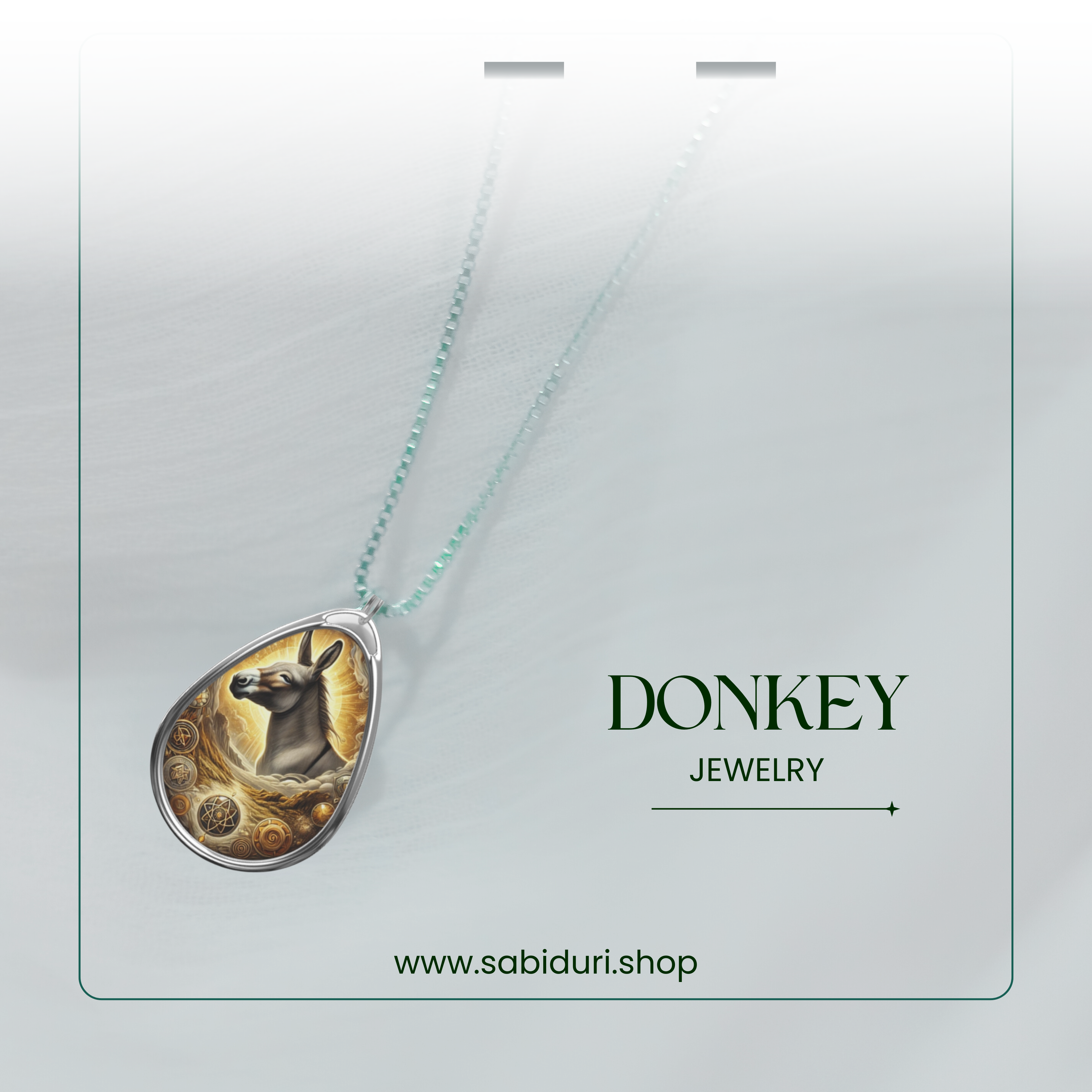 The donkey pendant necklace hangs gracefully on a semi-transparent background with soft lighting. The text "DONKEY JEWELRY" and the brand website "www.sabiduri.shop" are elegantly placed for a refined promotional aesthetic.