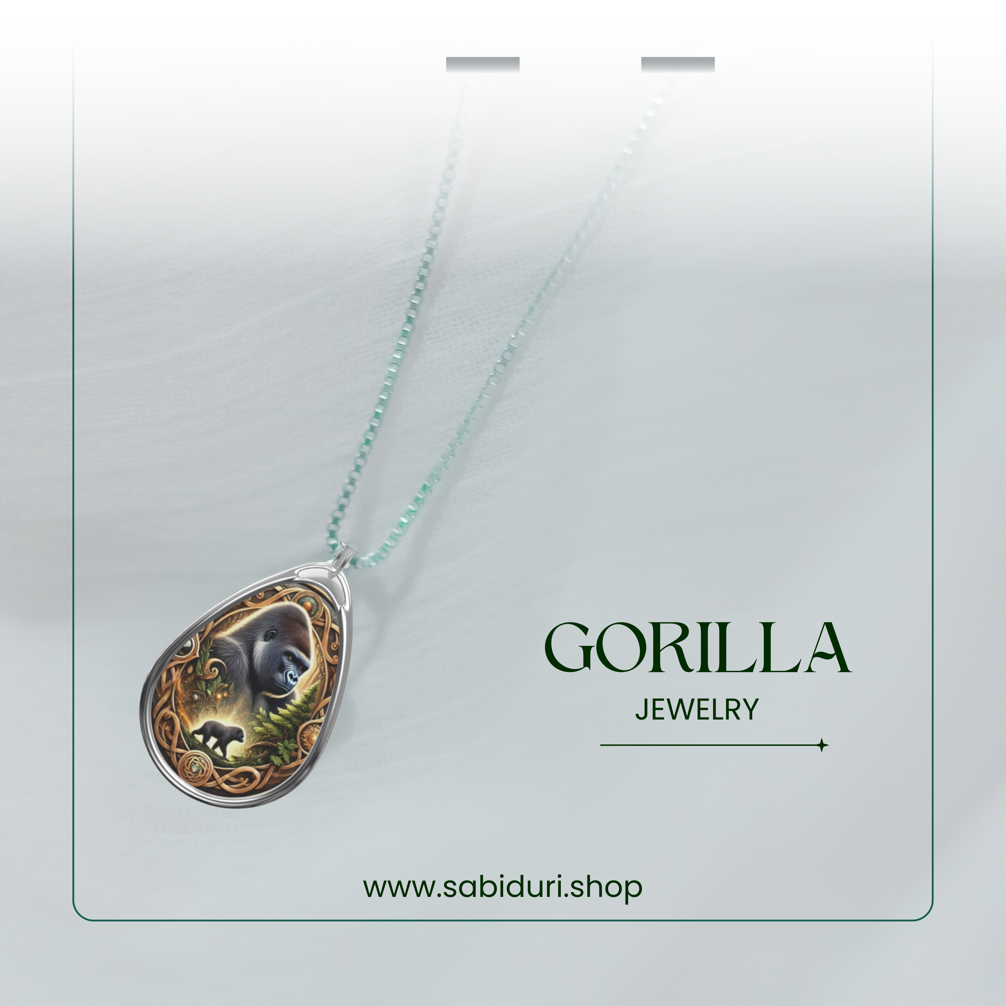 A stylish product showcase of the gorilla spirit animal necklace, suspended in mid-air against a soft white gradient background. The pendant's artistic gorilla depiction and detailed gold and green elements are complemented by the text "GORILLA JEWELRY" and "www.sabiduri.shop."