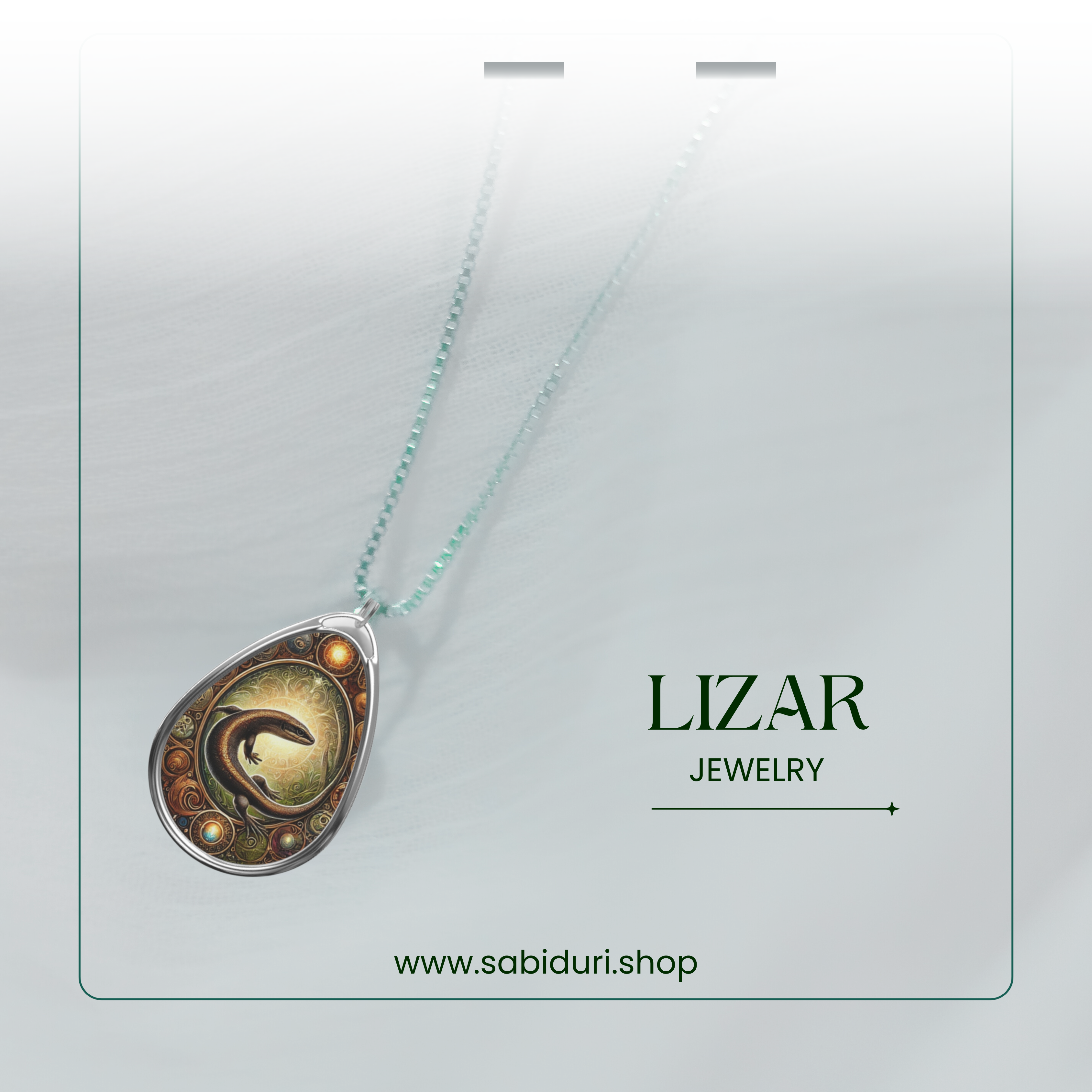 The Lizard pendant necklace is delicately displayed against a soft white gradient background. The necklace chain is faintly visible, giving the impression of floating. Below, the words "LIZARD JEWELRY" and "www.sabiduri.shop" are stylishly placed.