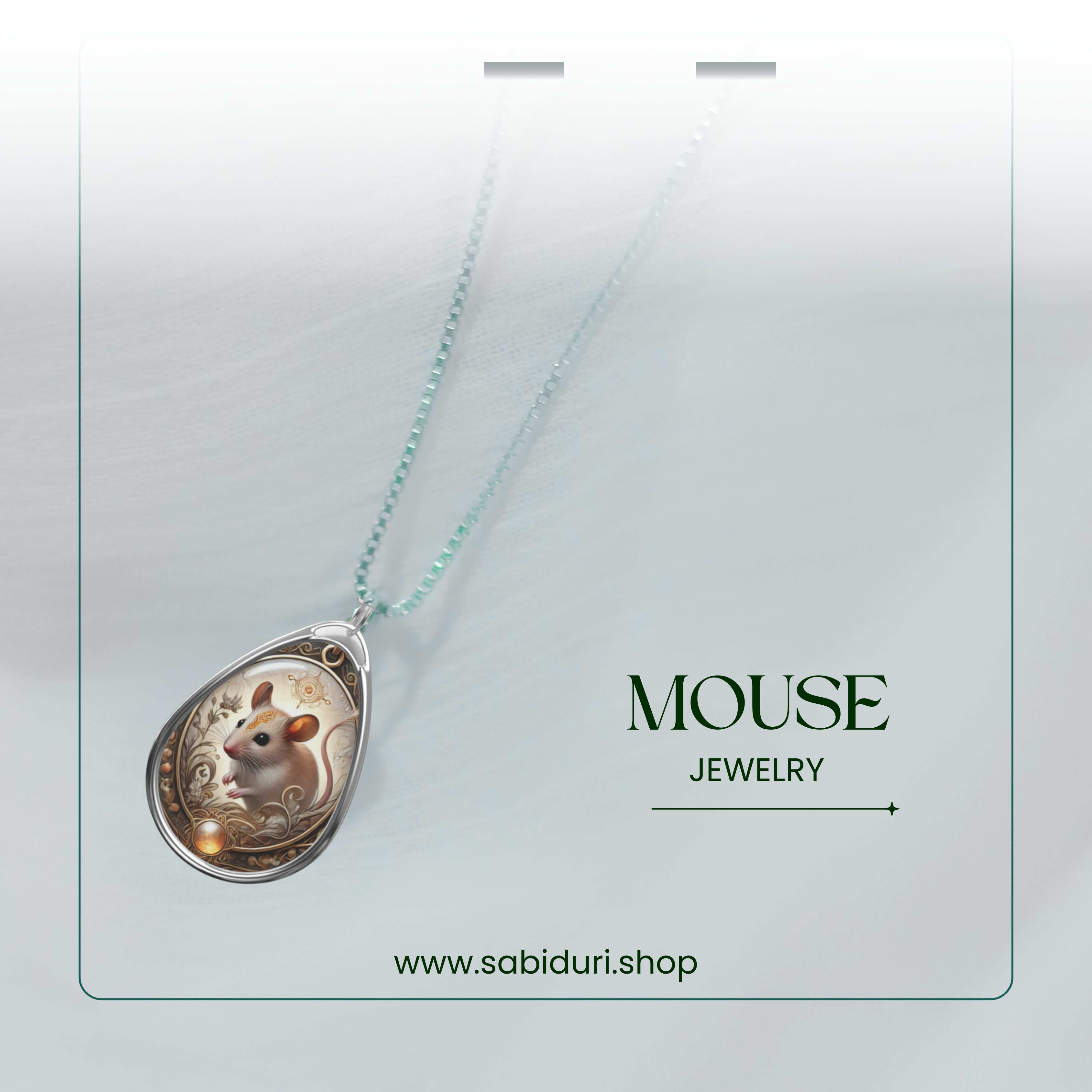 A detailed mouse pendant necklace showcased against a soft, blurred white background. The pendant design features a tiny mouse encircled by intricate swirls and floral elements, with golden hues adding warmth to the silver setting. The chain is a light teal color, complementing the overall design.