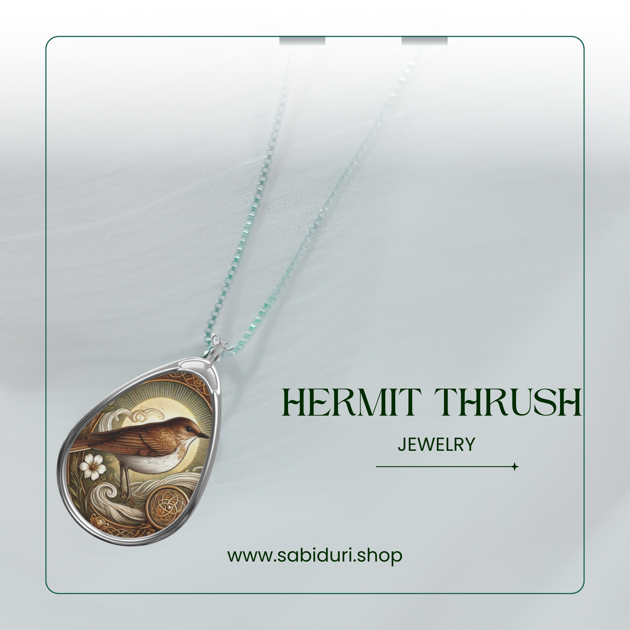 A close-up of a silver hermit thrush pendant necklace, featuring an earthy-toned design with a white flower and intricate swirling patterns. The pendant rests on a soft, white fabric backdrop with the words "HERMIT THRUSH JEWELRY" and the website "www.sabiduri.shop" in an elegant green font.