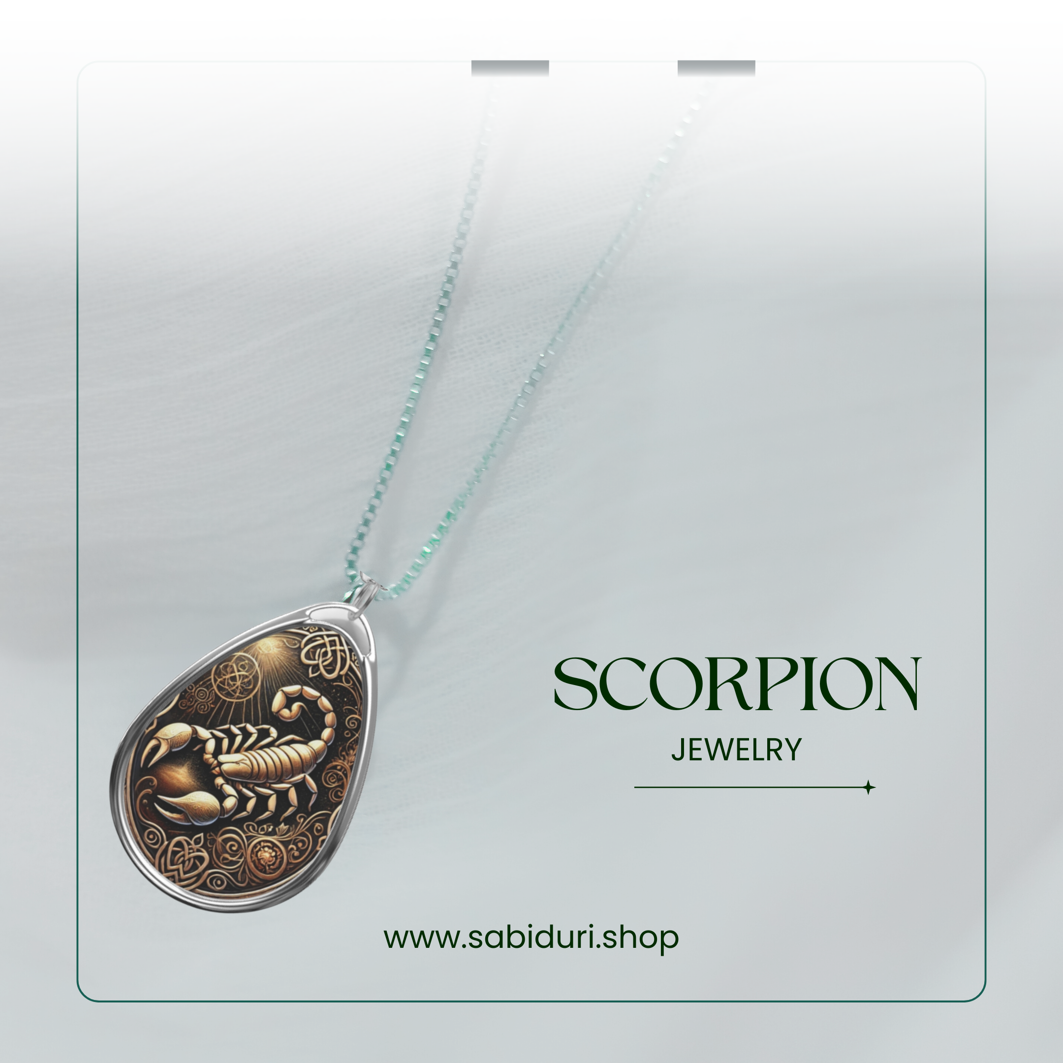A close-up of a silver scorpion pendant necklace, with an intricate golden-toned design featuring swirling patterns. The pendant is set against a soft white fabric background, with the words "SCORPION JEWELRY" and the website "www.sabiduri.shop" in a refined green font.