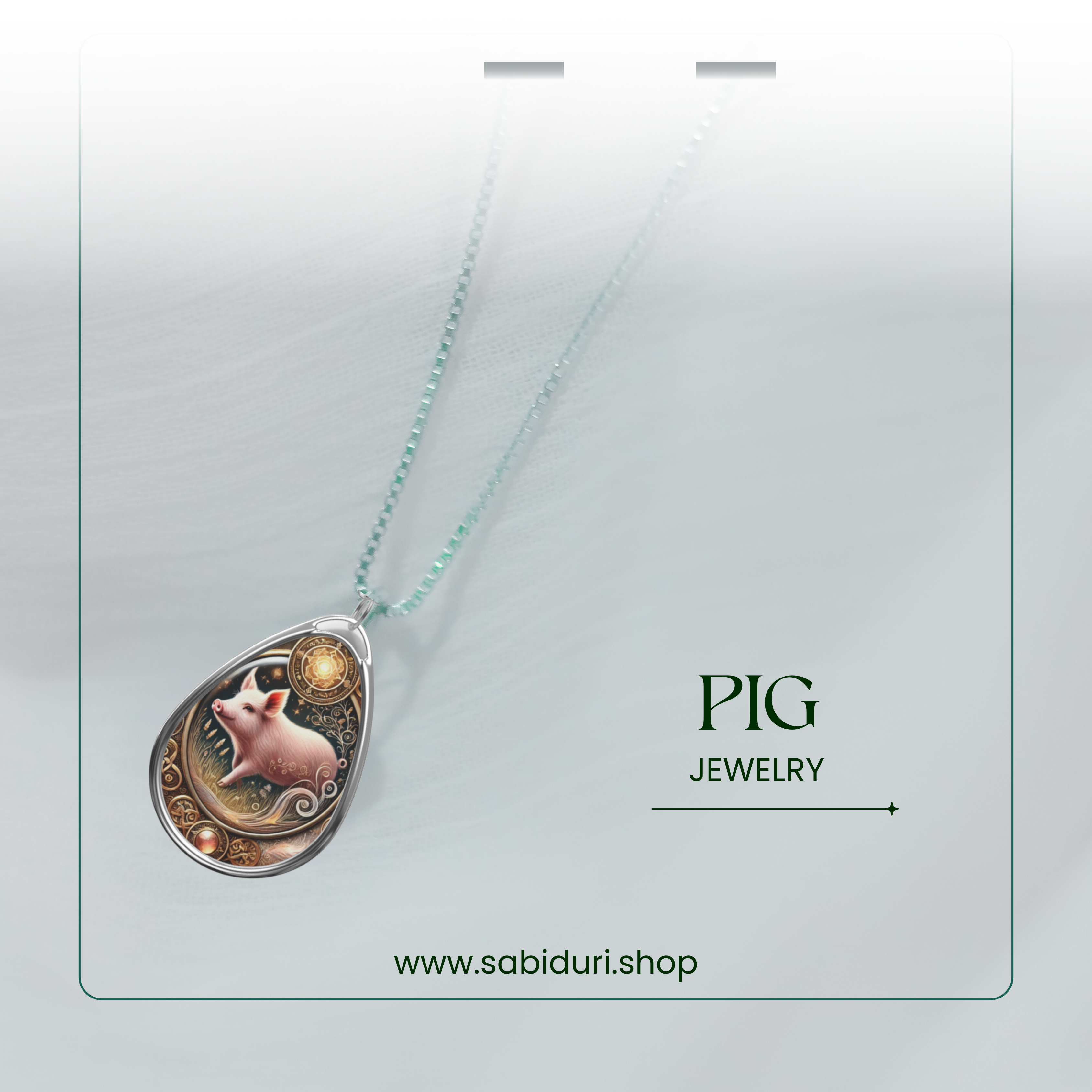 A pig-themed pendant necklace hanging from a light green beaded chain, set against a soft white background. The text "PIG JEWELRY" and "www.sabiduri.shop" are elegantly placed beside it.