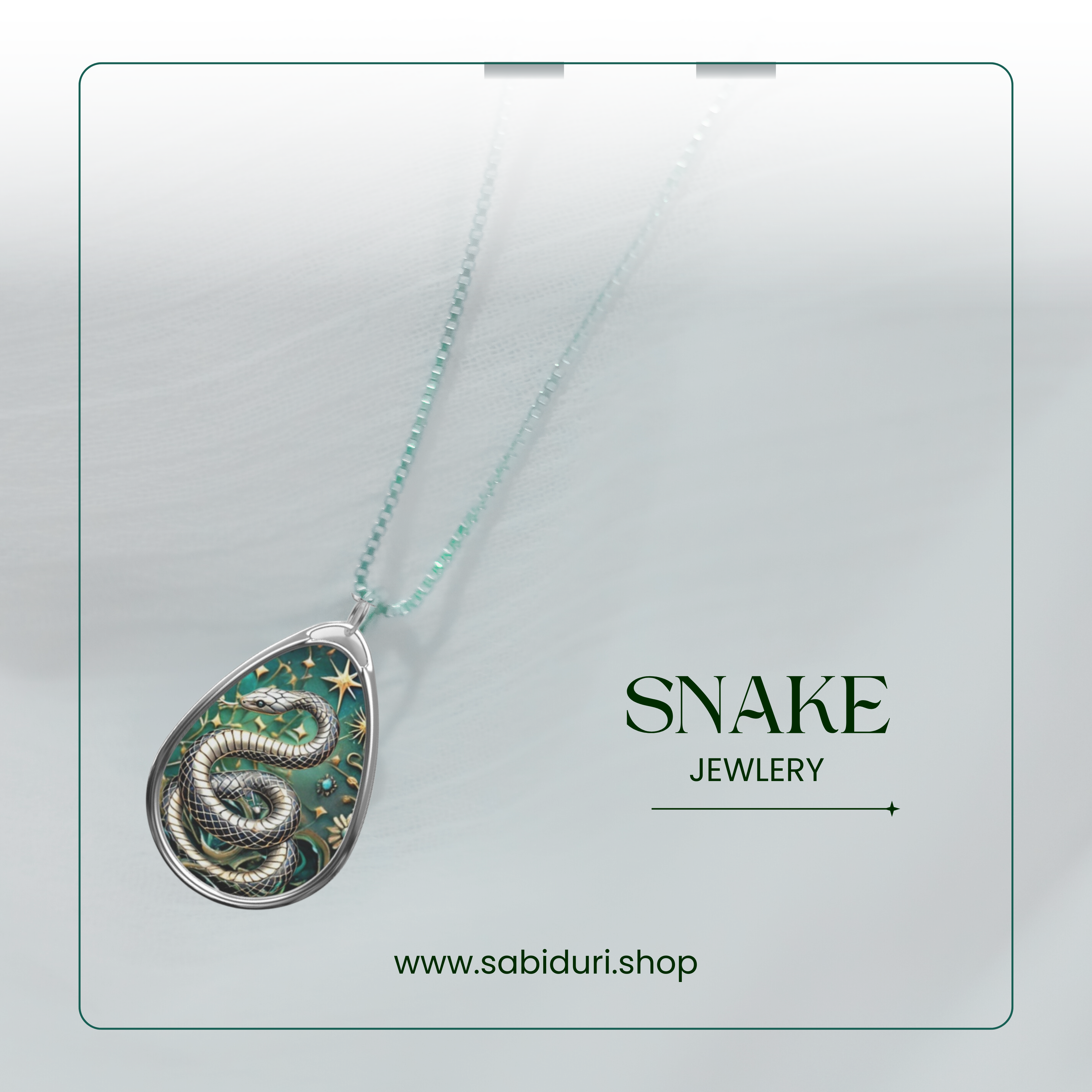 A snake pendant necklace with a silver snake coiled on a green background decorated with stars, set against a soft white background. The text "Snake Jewelry" and the website "www.sabiduri.shop" are shown in the image.