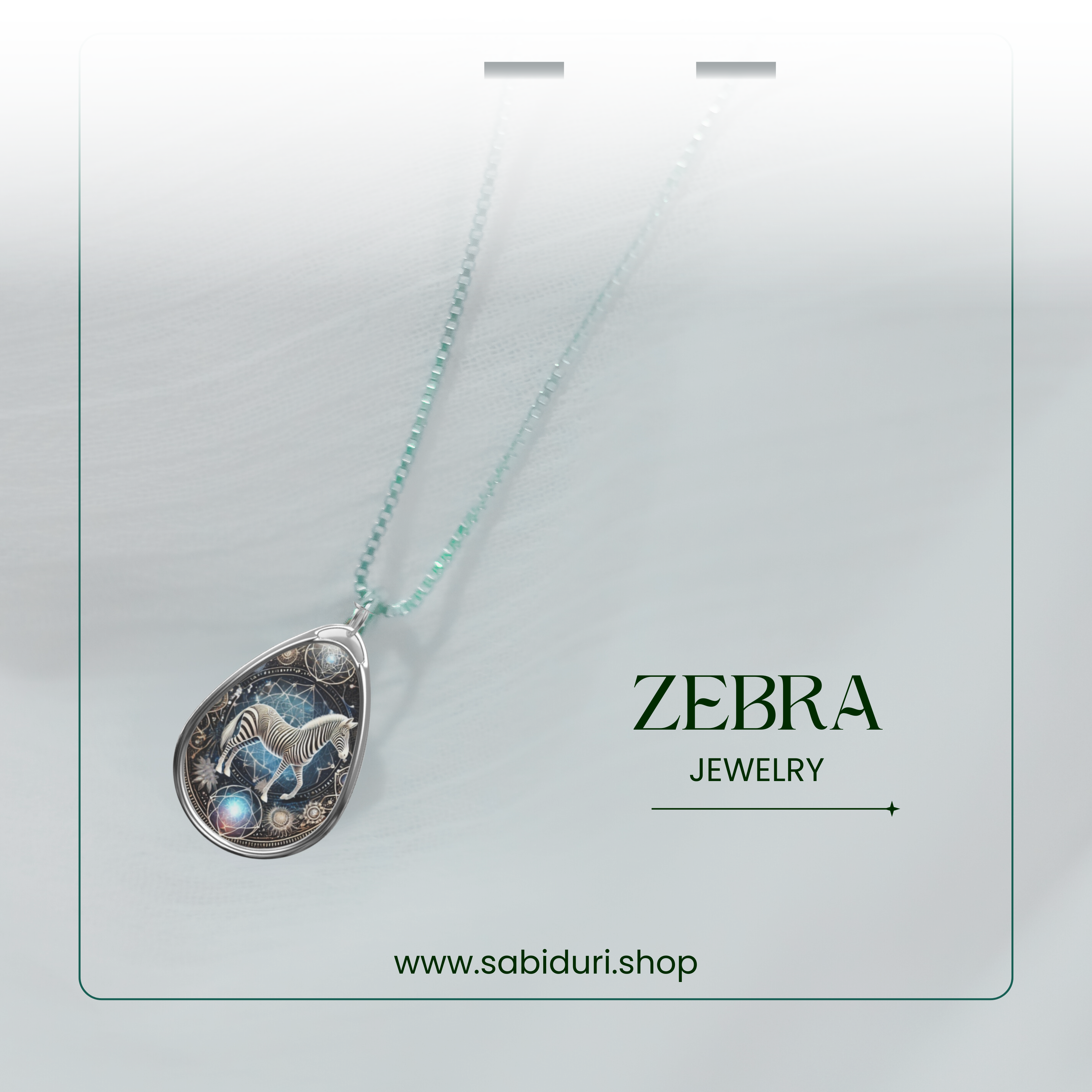 A close-up of the zebra pendant necklace on a delicate beaded chain, set against a soft white fabric background. The pendant's intricate silver details and glowing gemstones are highlighted, with "Zebra Jewelry" and the website "www.sabiduri.shop" in the lower section.