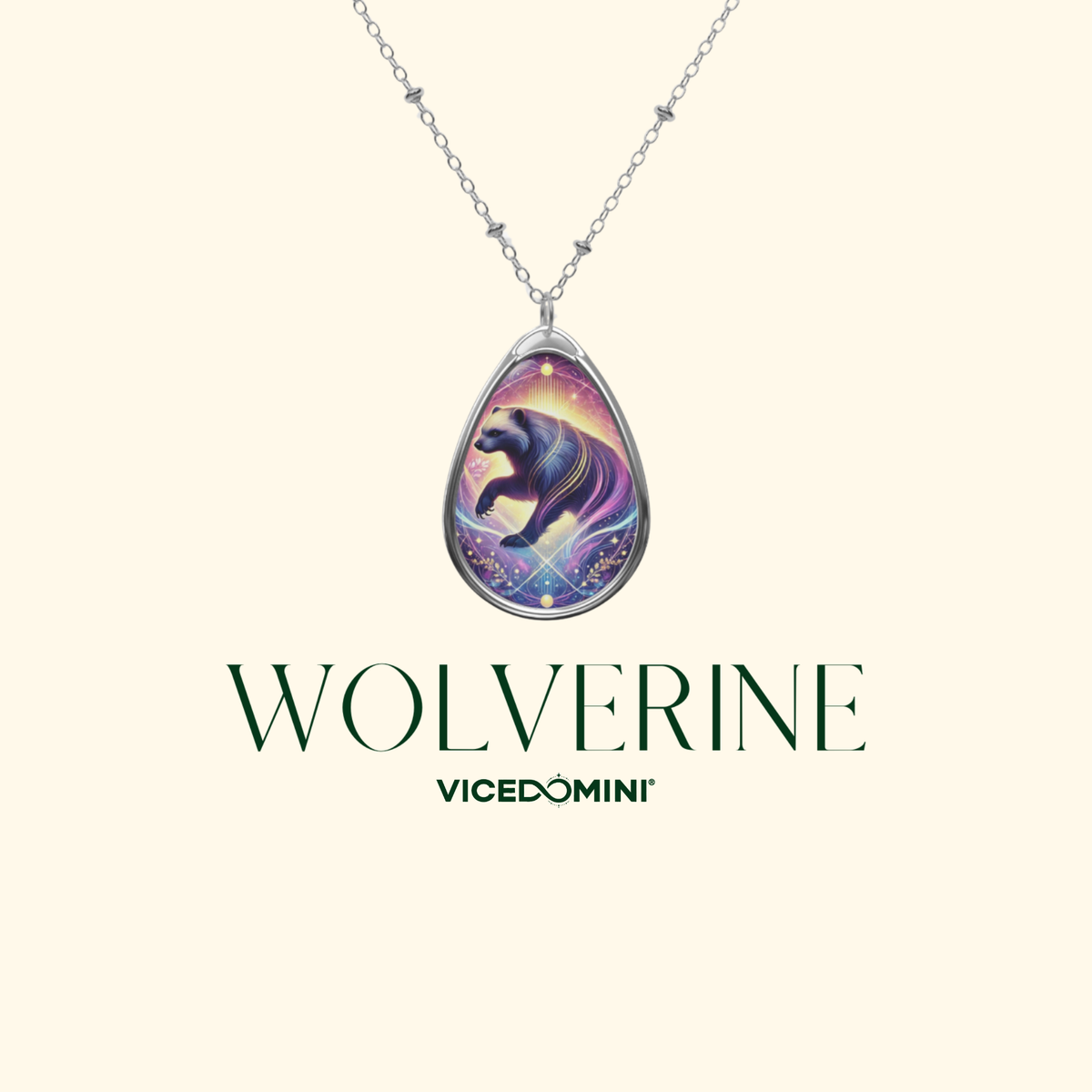 A silver-tone pendant necklace featuring a teardrop-shaped charm with a colorful illustration of a black cat on a purple and blue cosmic background. The necklace is displayed against a light cream background with the text 'WOLVERINE' and 'VICEDOMINI' printed below.