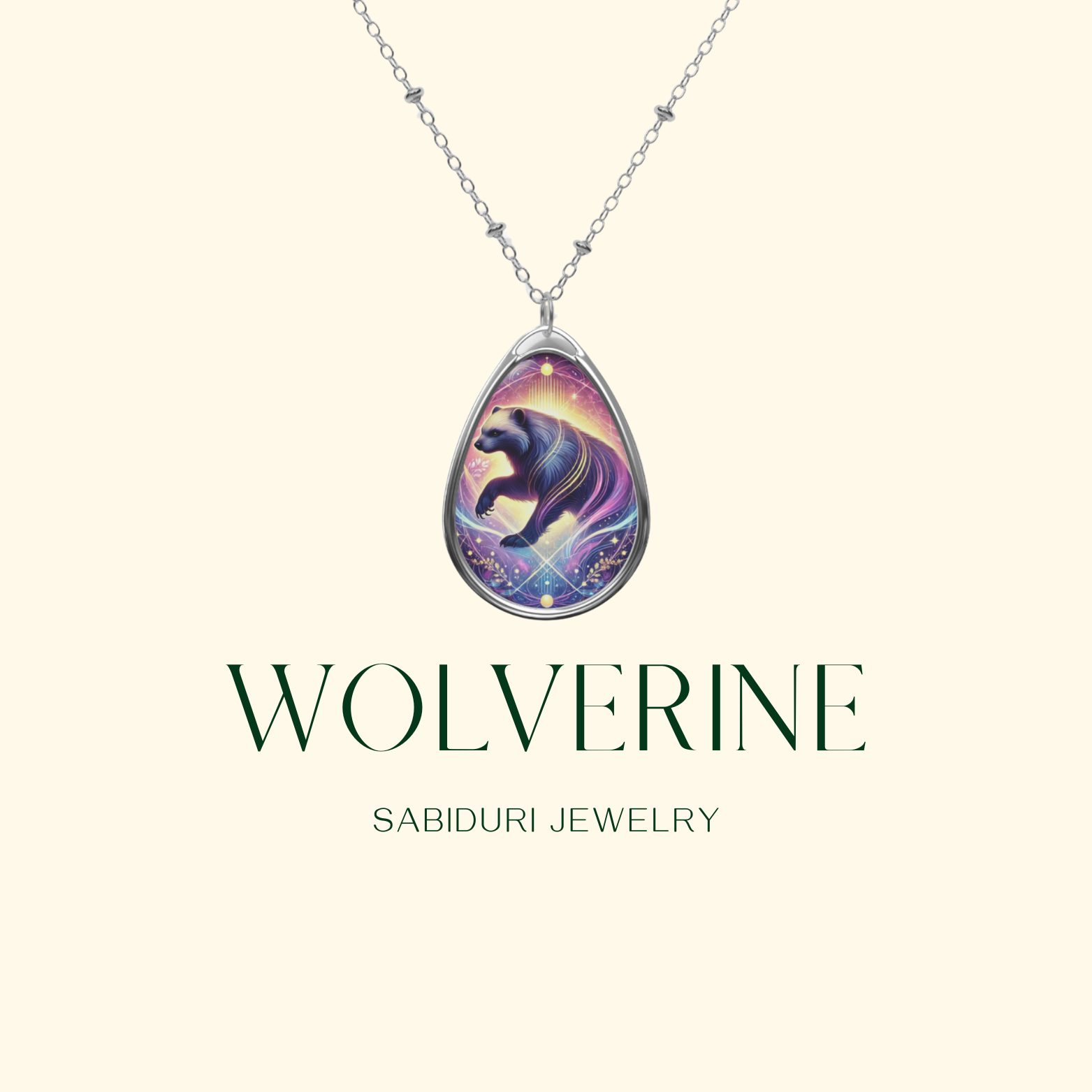 A clean, minimalistic product image of a silver teardrop-shaped wolverine pendant necklace, featuring an ethereal wolverine illustration in a cosmic color scheme. The words "WOLVERINE" and "SABIDURI JEWELRY" are displayed below the pendant on a cream-colored background.