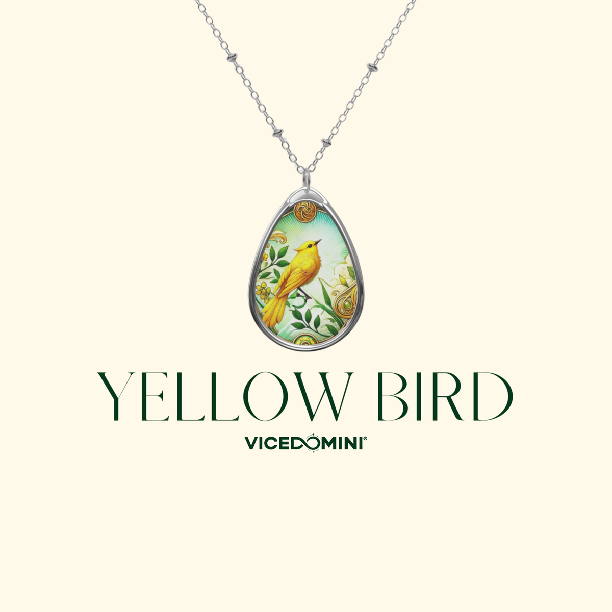 A teardrop-shaped pendant necklace featuring a yellow bird perched on a branch with green leaves, suspended from a silver chain. The pendant is centered on a light cream background with the text 'YELLOW BIRD' and 'VICEDOMINI' underneath.