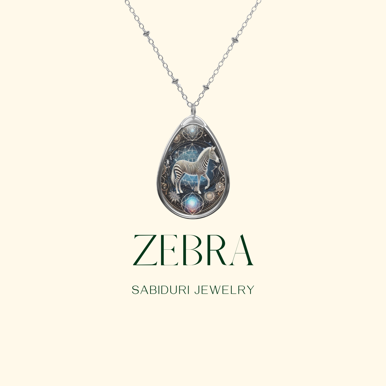 A digital promotional image showcasing a zebra pendant necklace on a minimalist cream background. The pendant is adorned with a celestial and cosmic design, and the text "Zebra - Sabiduri Jewelry" is displayed in elegant typography.